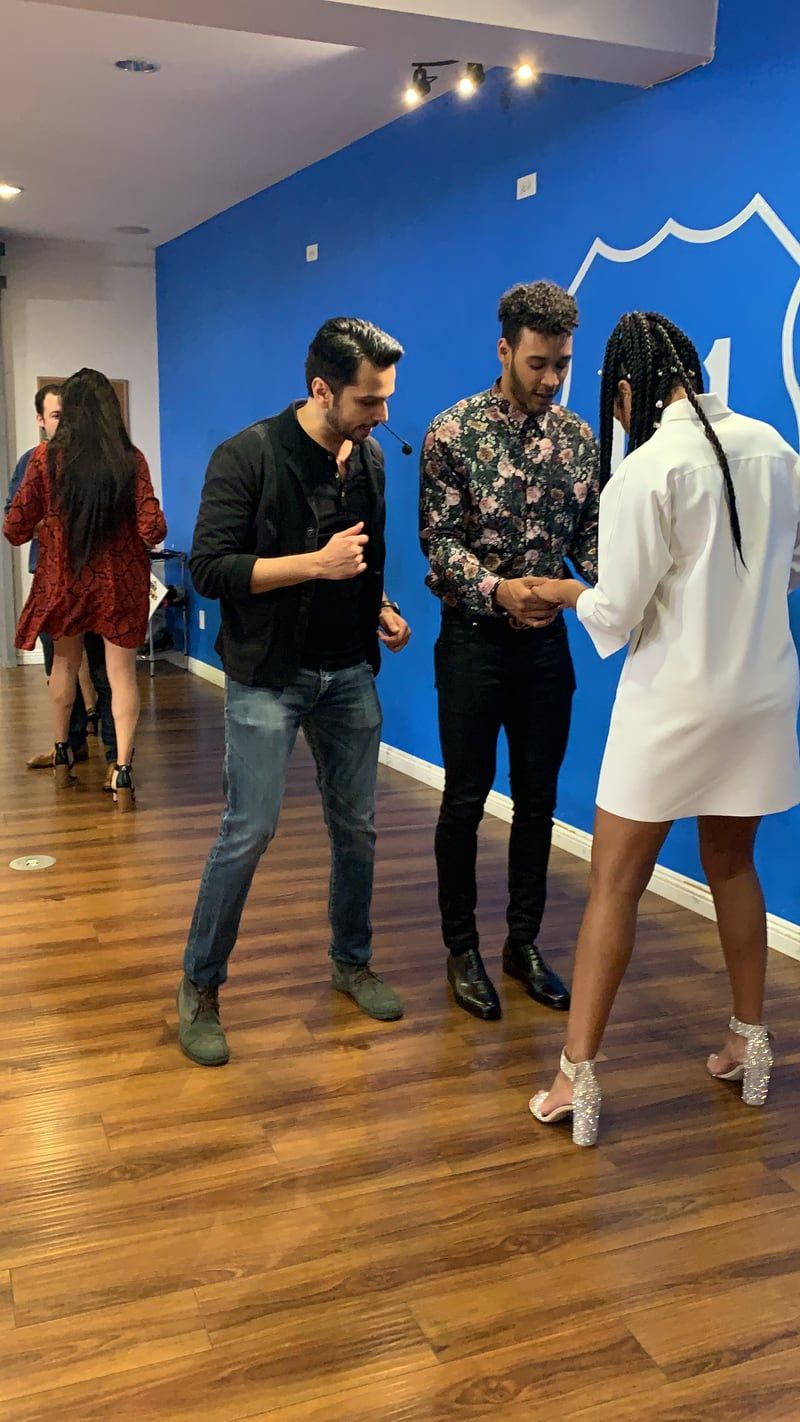 Avissh coaching a couple through a salsa partner connection at a partner studio