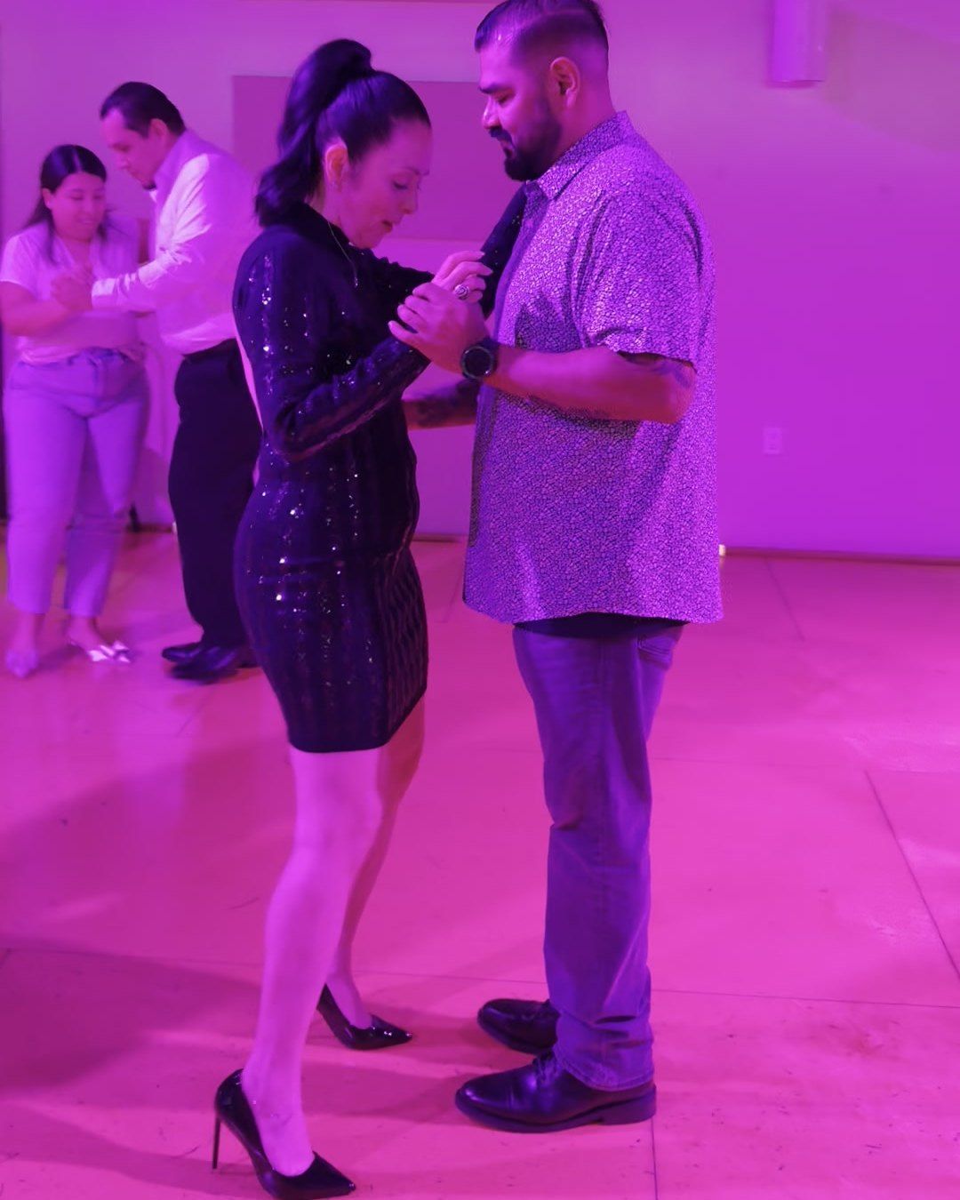 A couple in a close bachata hold at Rhythms & Romance 2025
