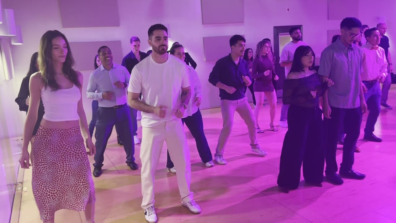 Rows of students in a packed Rhythm & Romance salsa lesson in Los Angeles