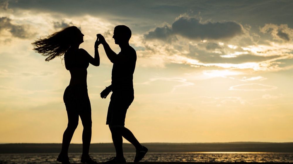 A couple dancing at sunset