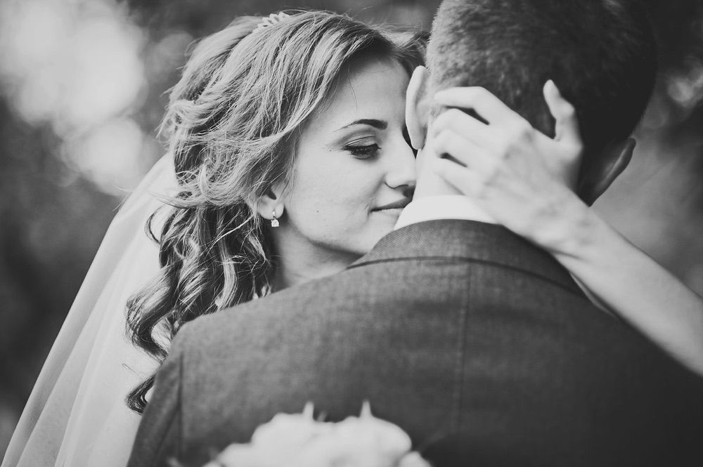 A bride twirling her dress while the groom looks on